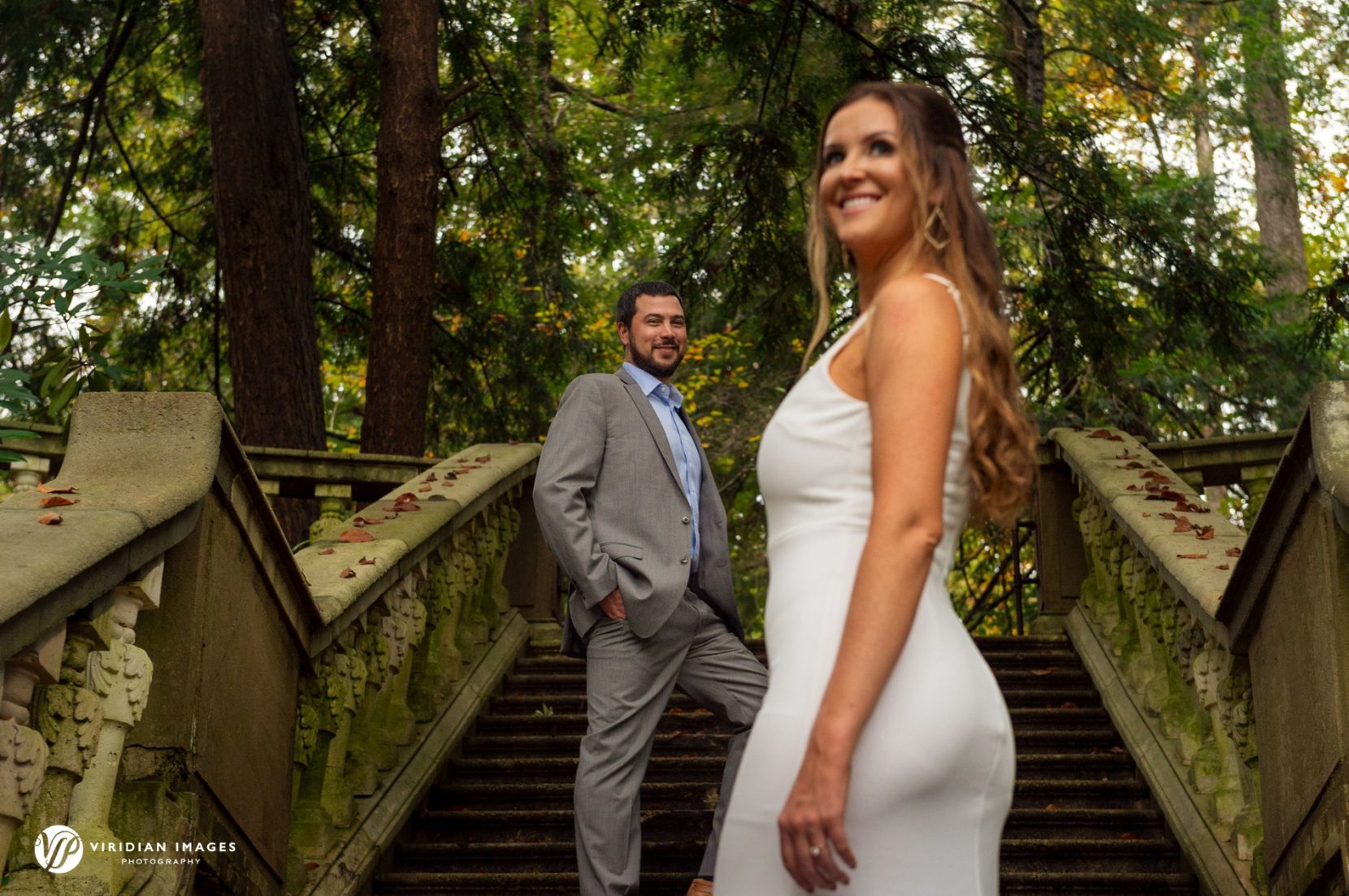 couple posed in layers on stone steps during fall engagement session in Atlanta
