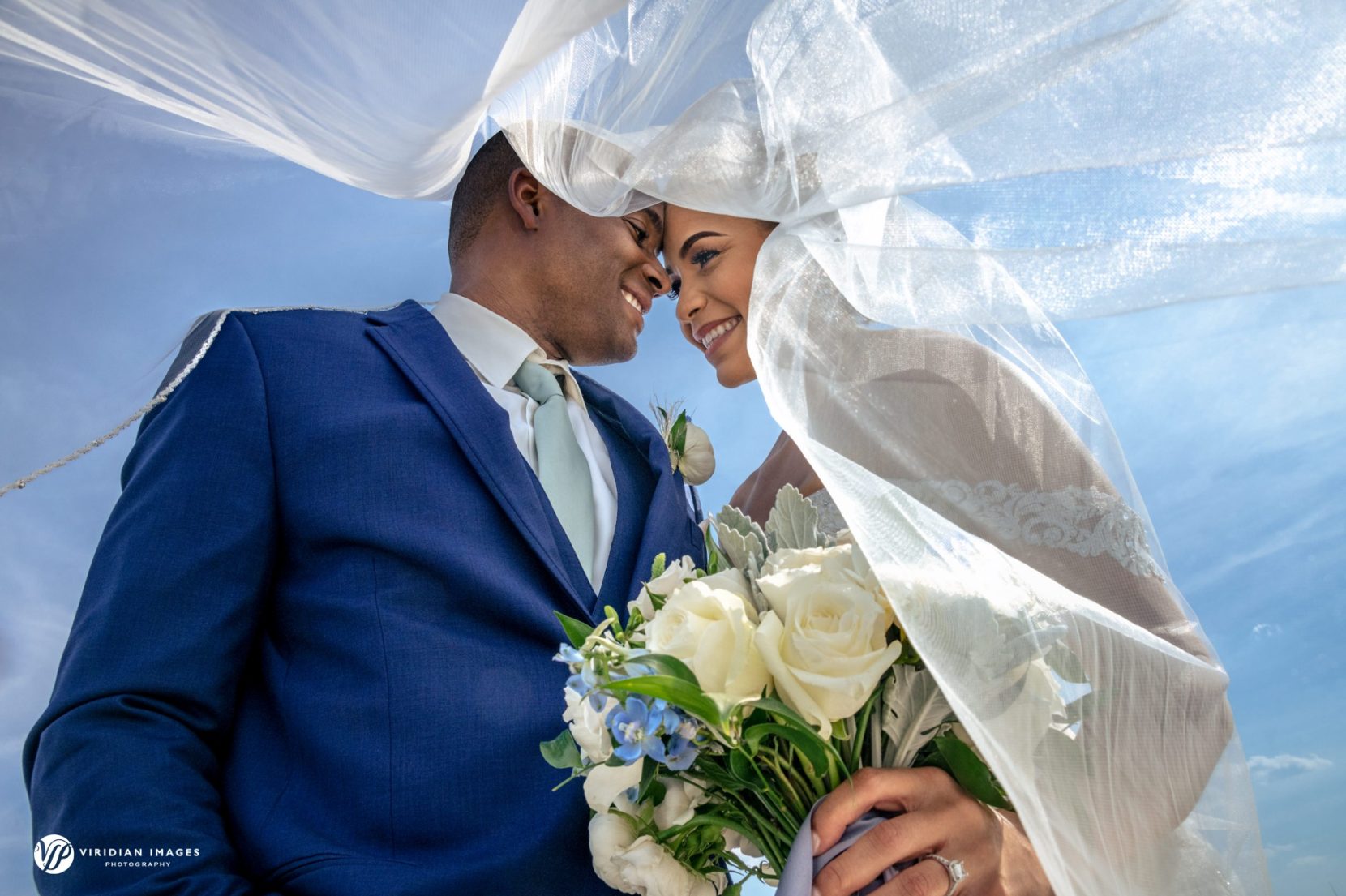 wedding portrait under veil against blue sky at Ventanas Atlanta