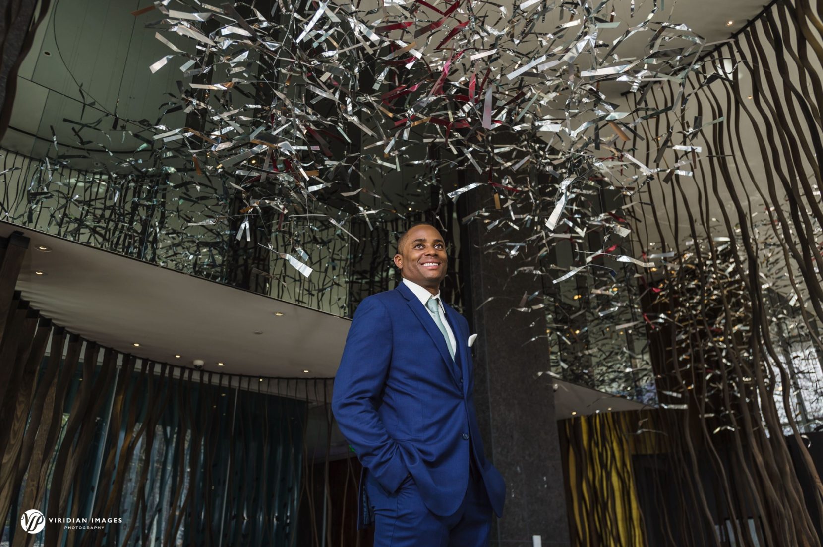 Groom standing on coffee table in lobby at W Hotel downtown Atlanta wedding