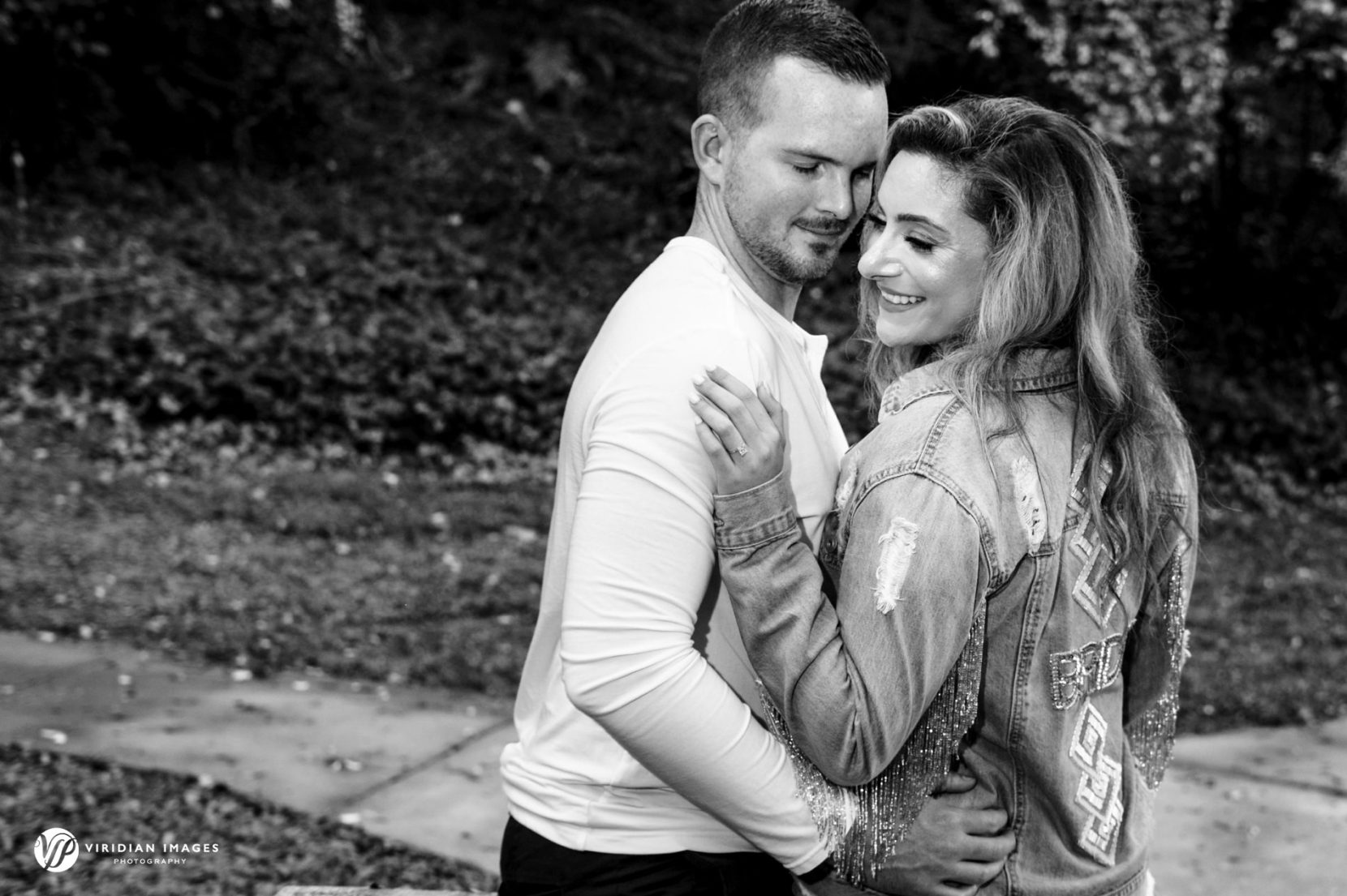 romantic photo of couple with bride wearing a custom jean jacket