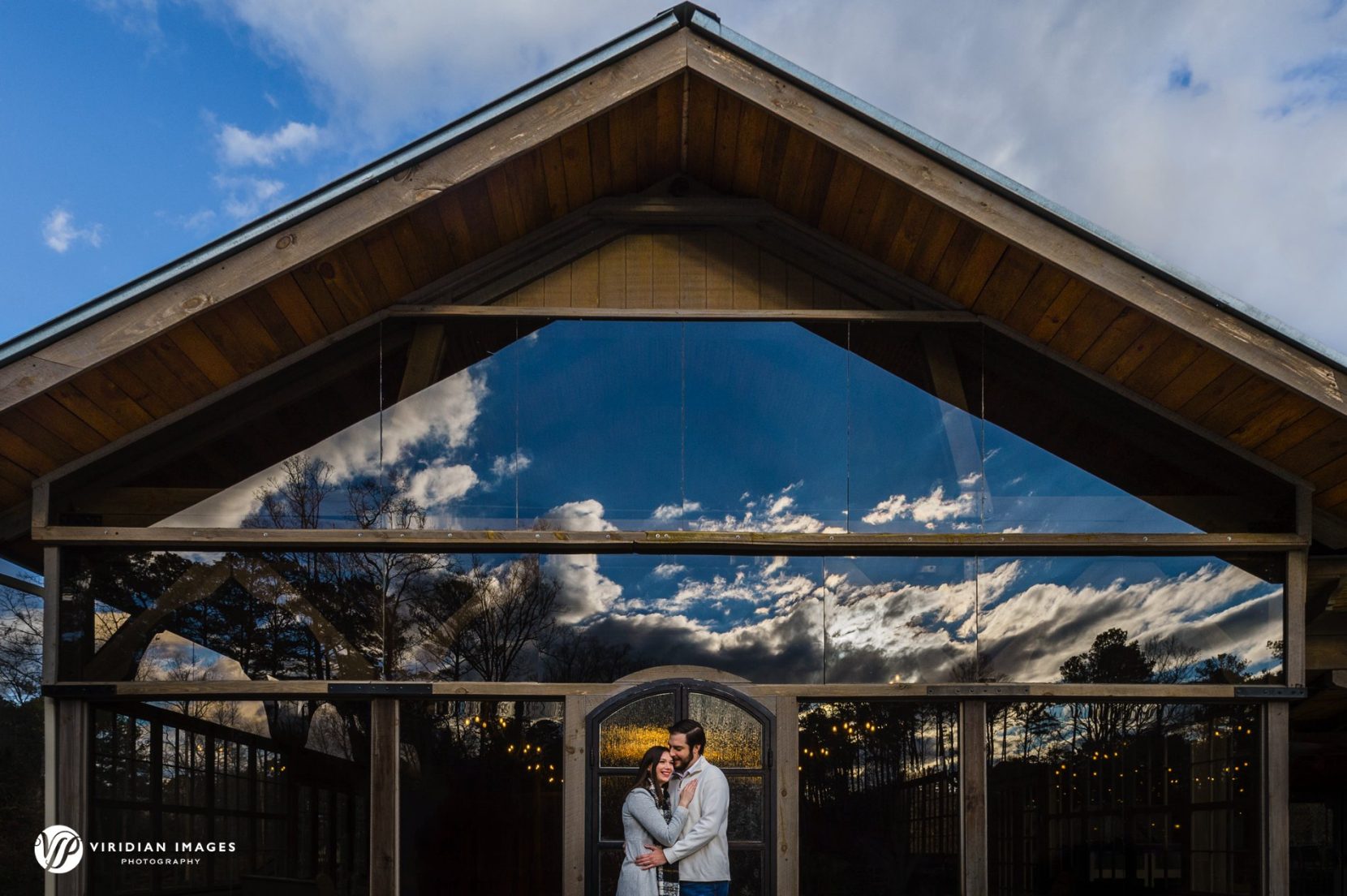 Creative engagement portrait using window reflections during a winter session at Rocky Lake Estate