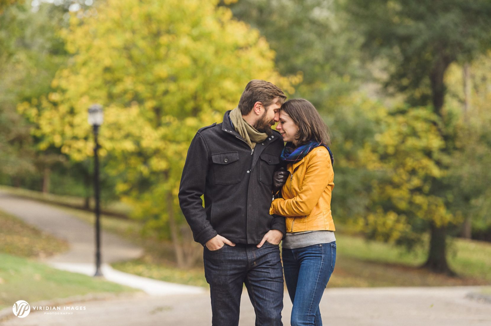 Couple stopping along path during engagement session in Grant Park Atlanta.