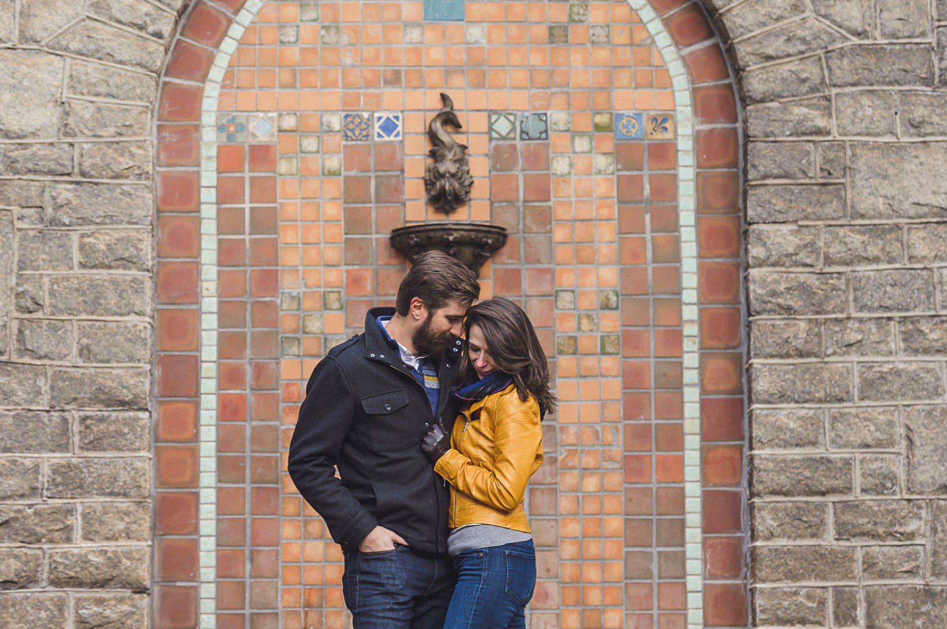 Creative engagement photo of couple standing in front of historic fountain at Grant Park Atlanta.