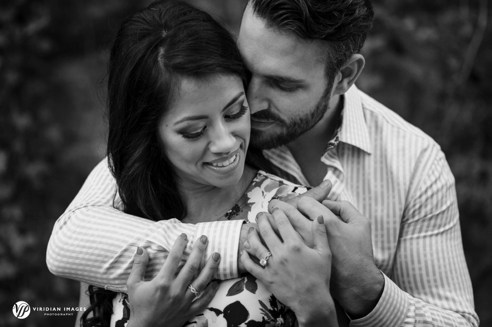 Romantic couple embrace during engagement session at Piedmont Park