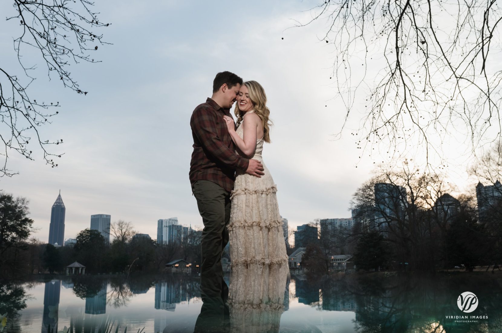Atlanta skyline sunset engagement portraits against lake at Piedmont Park