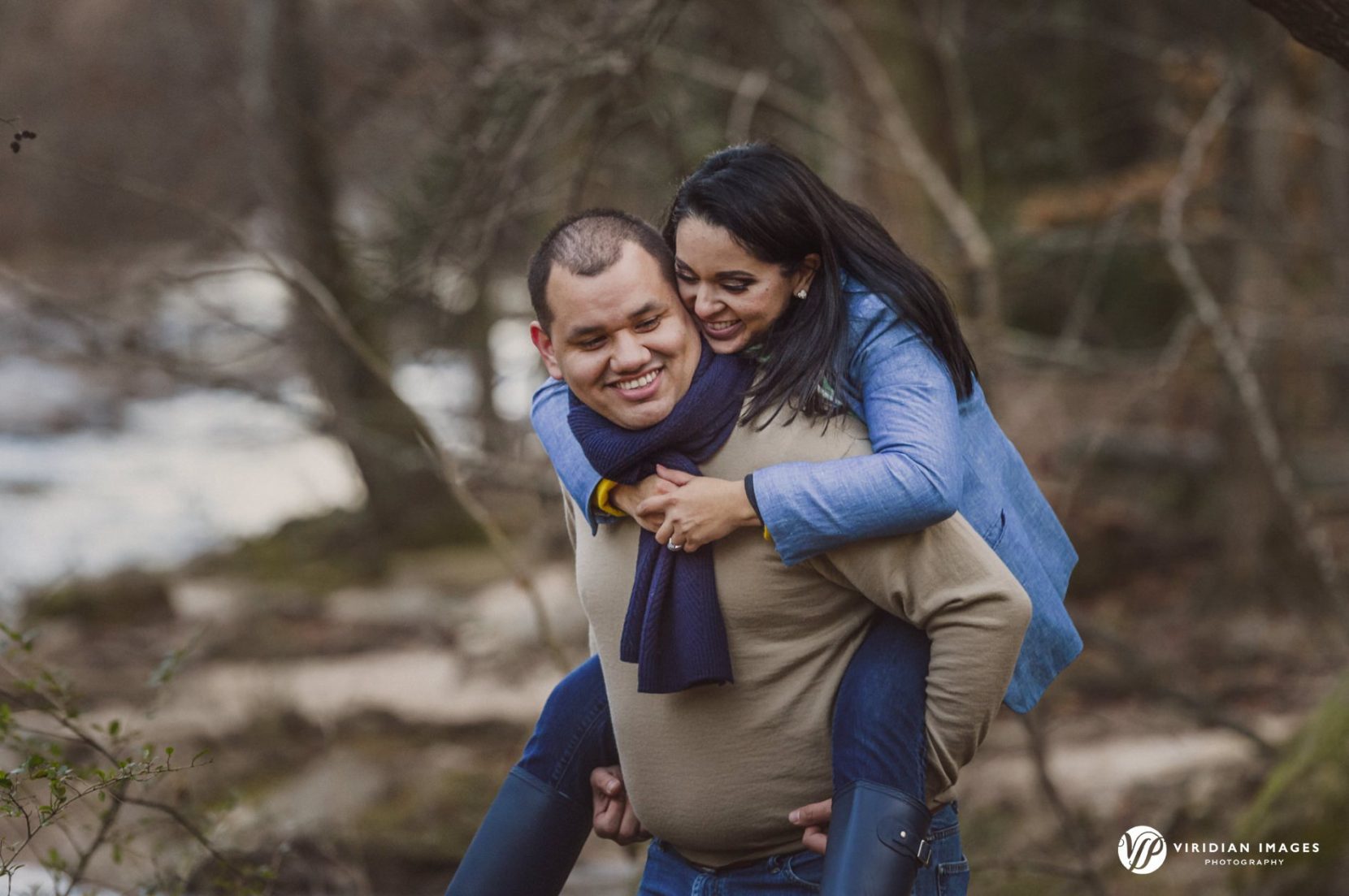 Couple having fun piggy-back ride during Sope Creek Trail winter engagement session
