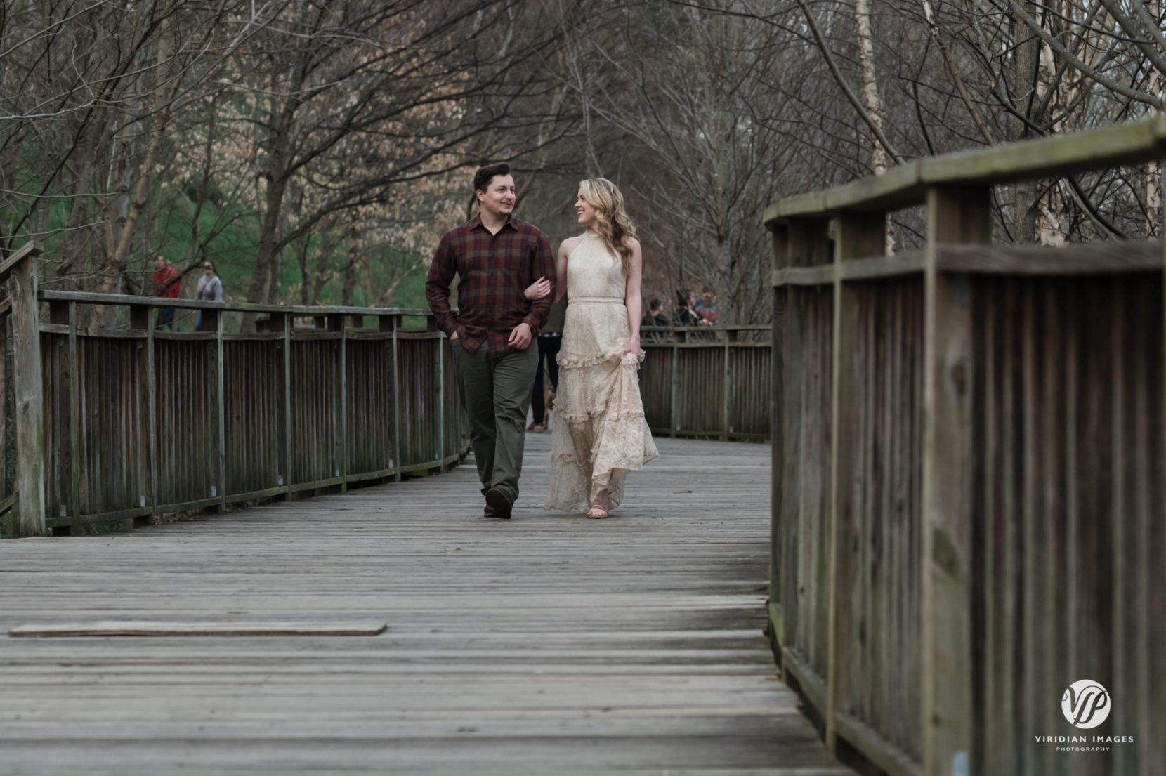 Bride-to-be wearing a cream lace dress during a winter engagement session in Atlanta