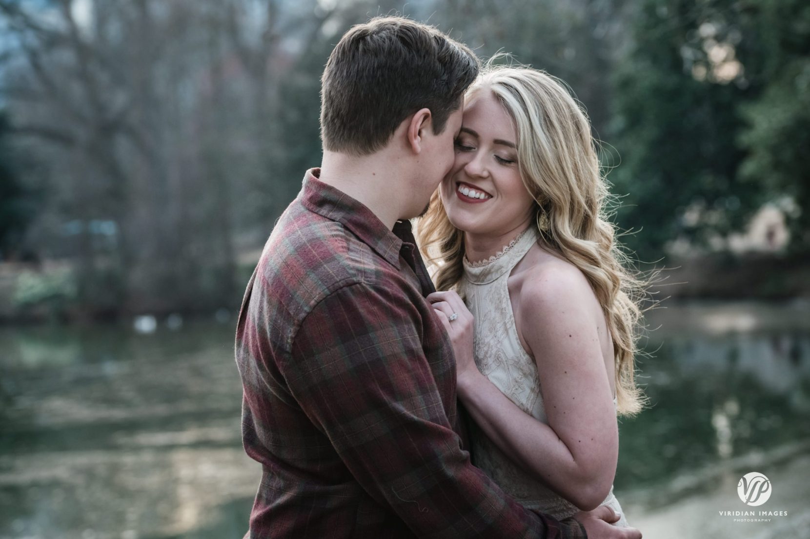 Romantic winter engagement photos by lake at Piedmont Park in Atlanta
