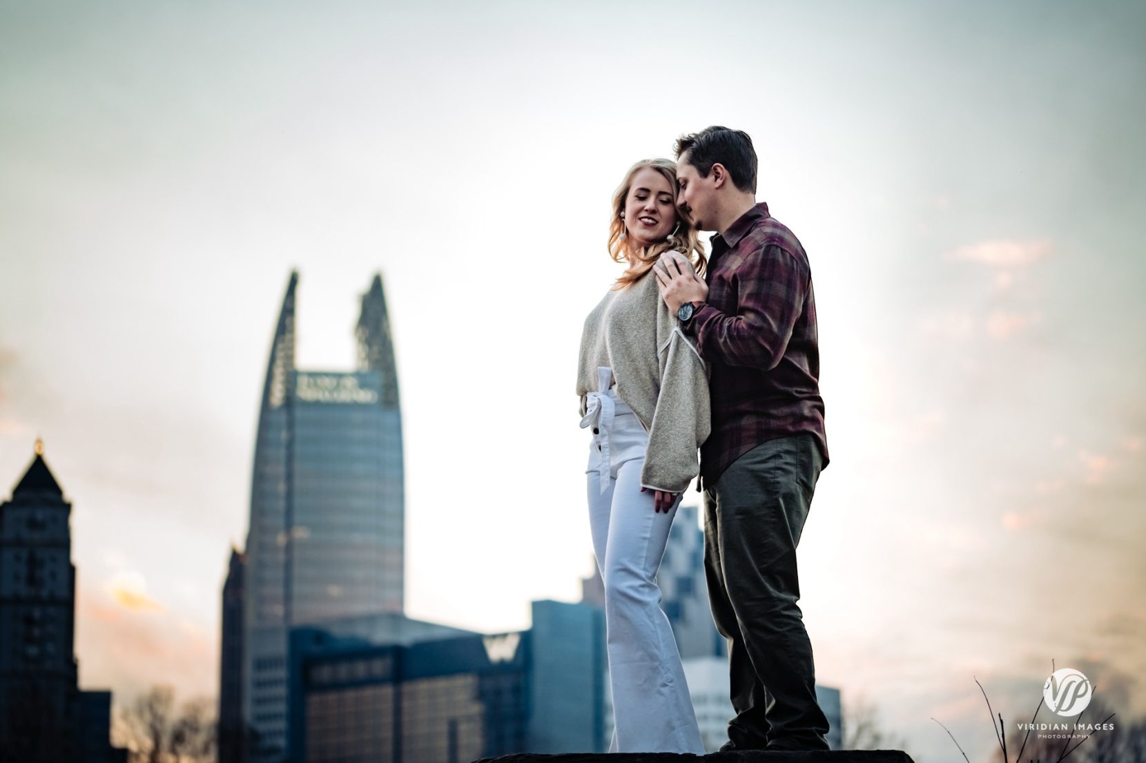 Atlanta skyline sunset engagement portraits at Piedmont Park stone wall in winter