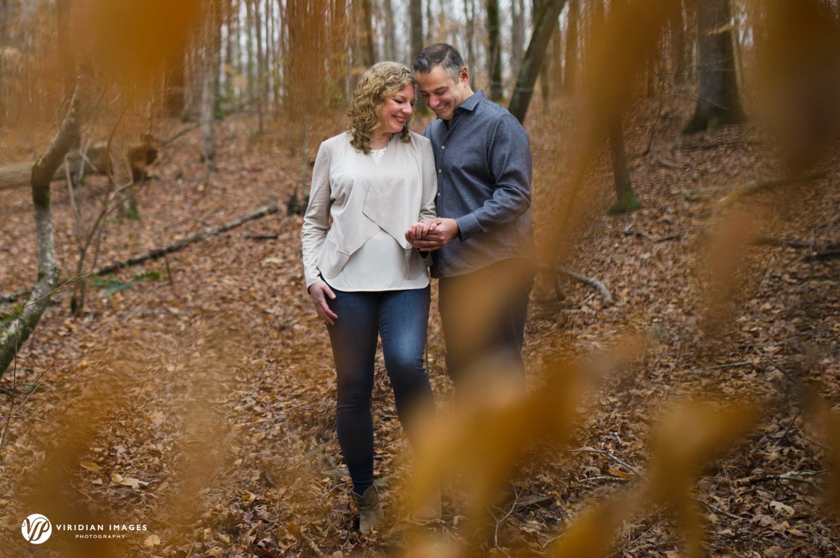 Private moment caught between trees during Sweetwater Creek engagement session