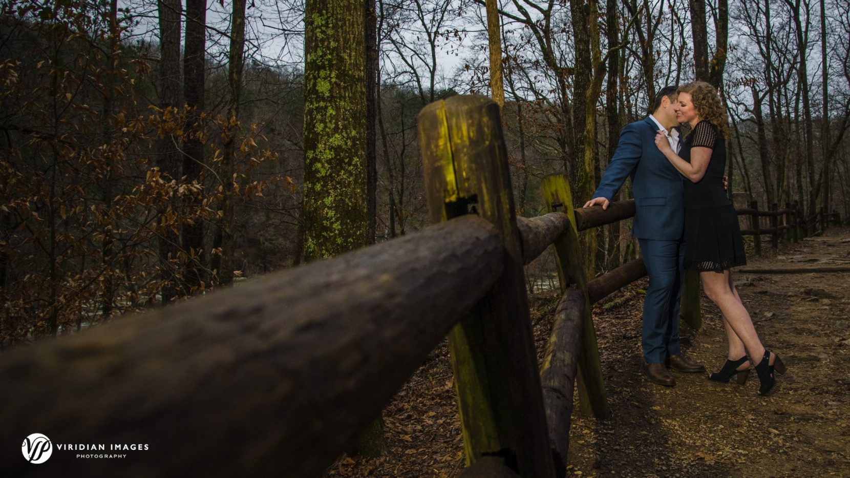 Couple embrace along wooded path for at Sweetwater Creek