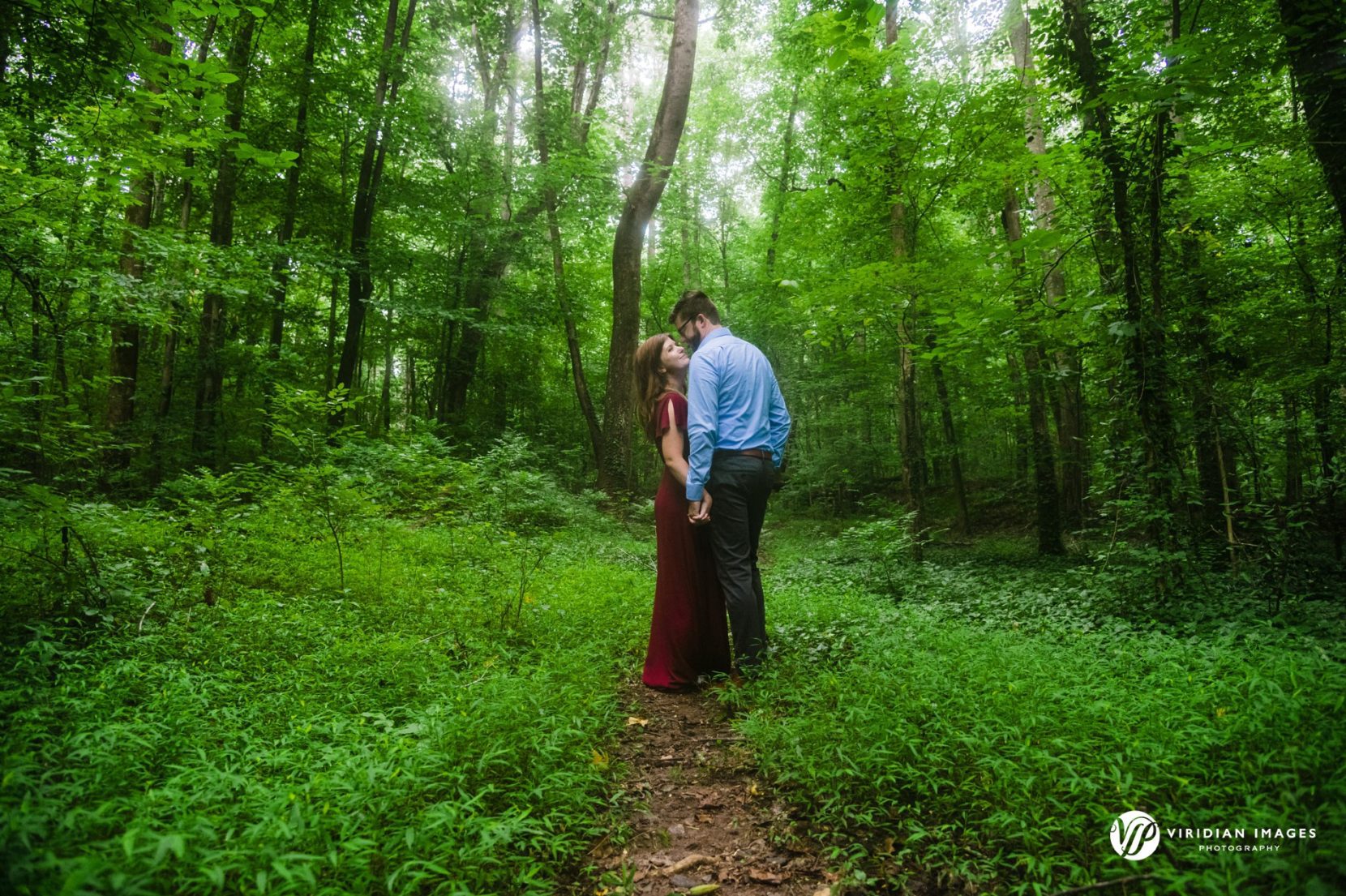 Couple in the woods during engagement session at Cascade Springs park