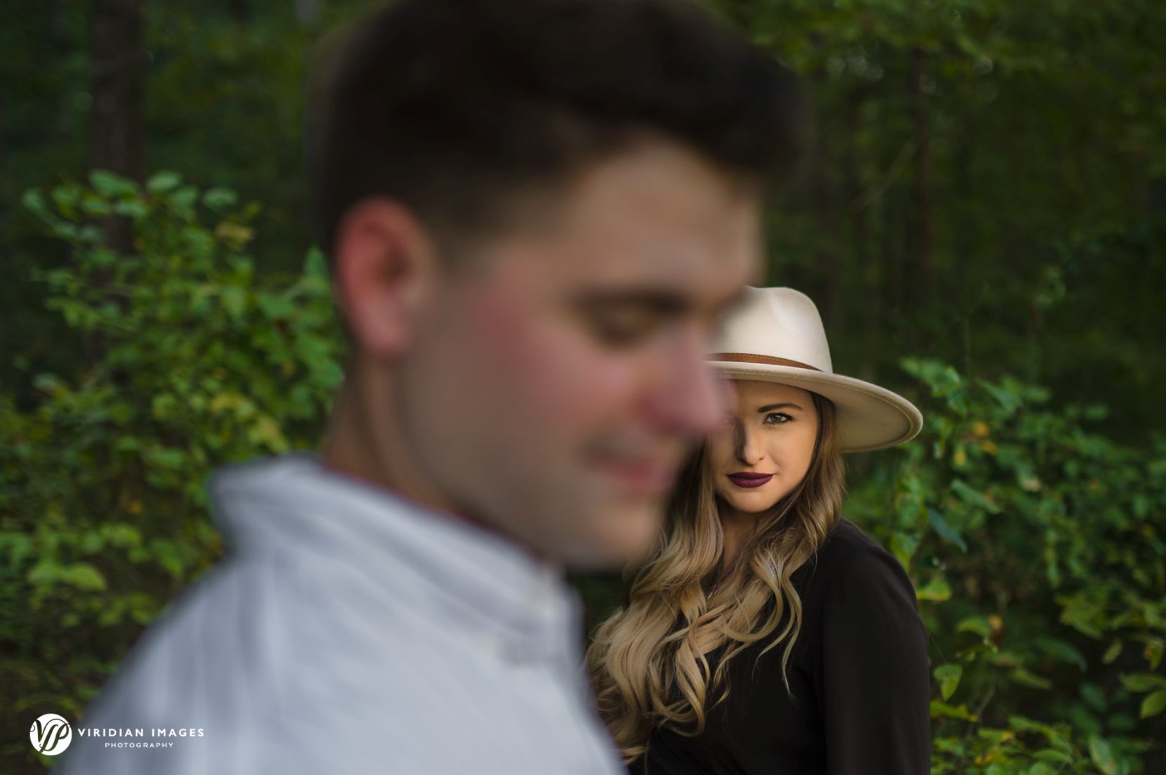 Editorial and romantic layered photo of engaged couple at Sweetwater Creek park