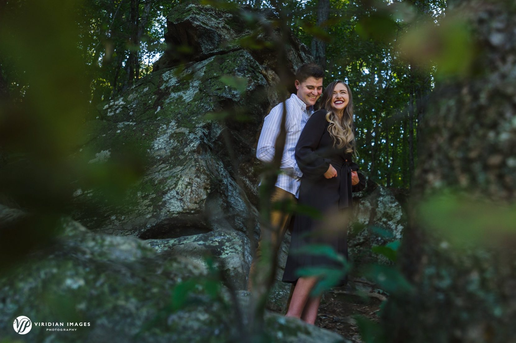 Photo of couple during sweetwater creek through green leaves engagement session