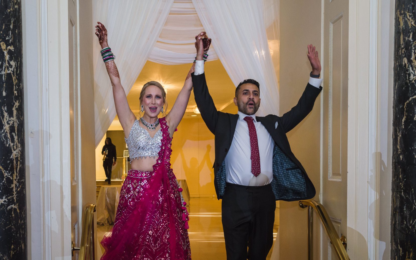 Bride and groom enter Biltmore Ballrooms during wedding reception