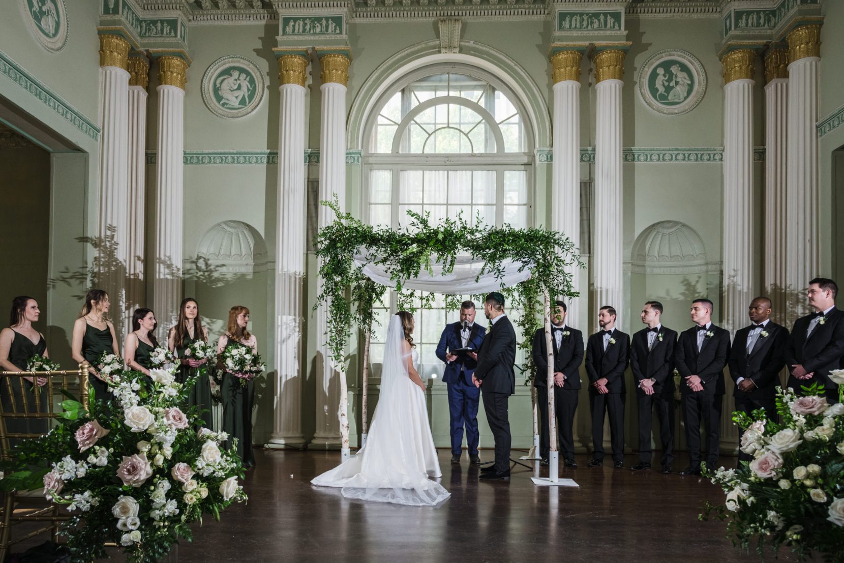 Wedding ceremony at floral altar inside Biltmore Ballrooms Atlanta