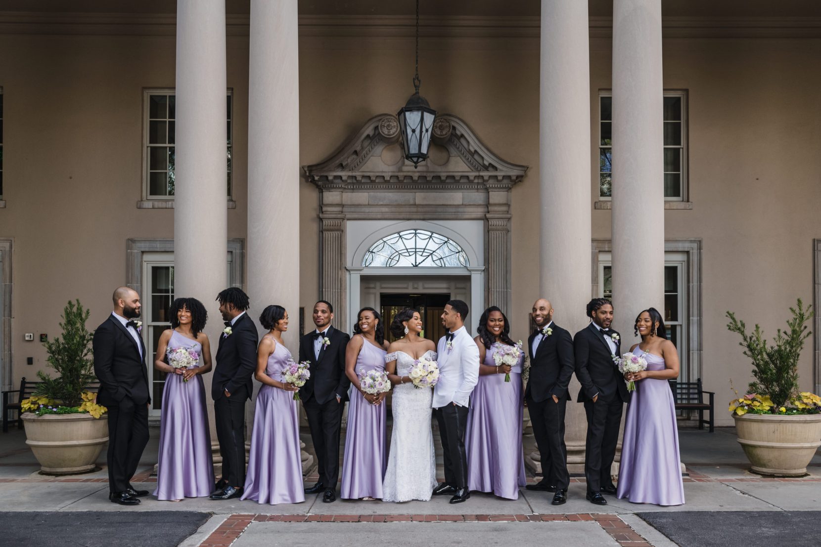 Wedding party portrait in front of columns of Biltmore Ballrooms Atlanta