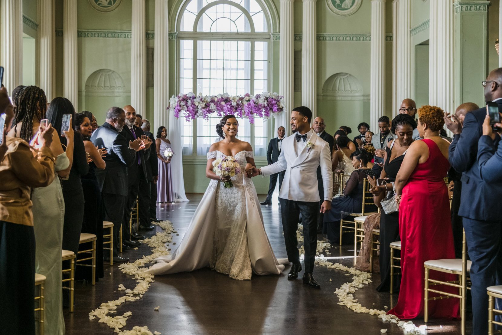 Guests reacting during newly married couple walking down aisle at Biltmore Ballrooms Atlanta