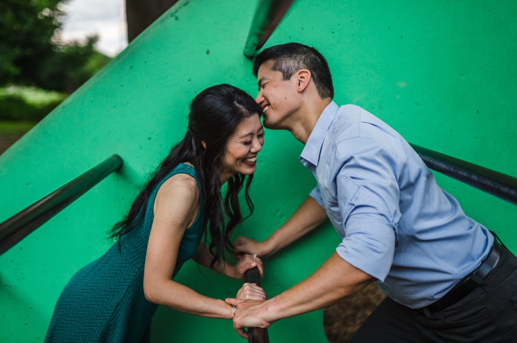 Couple playing in playground at Piedmont Park during engagement session