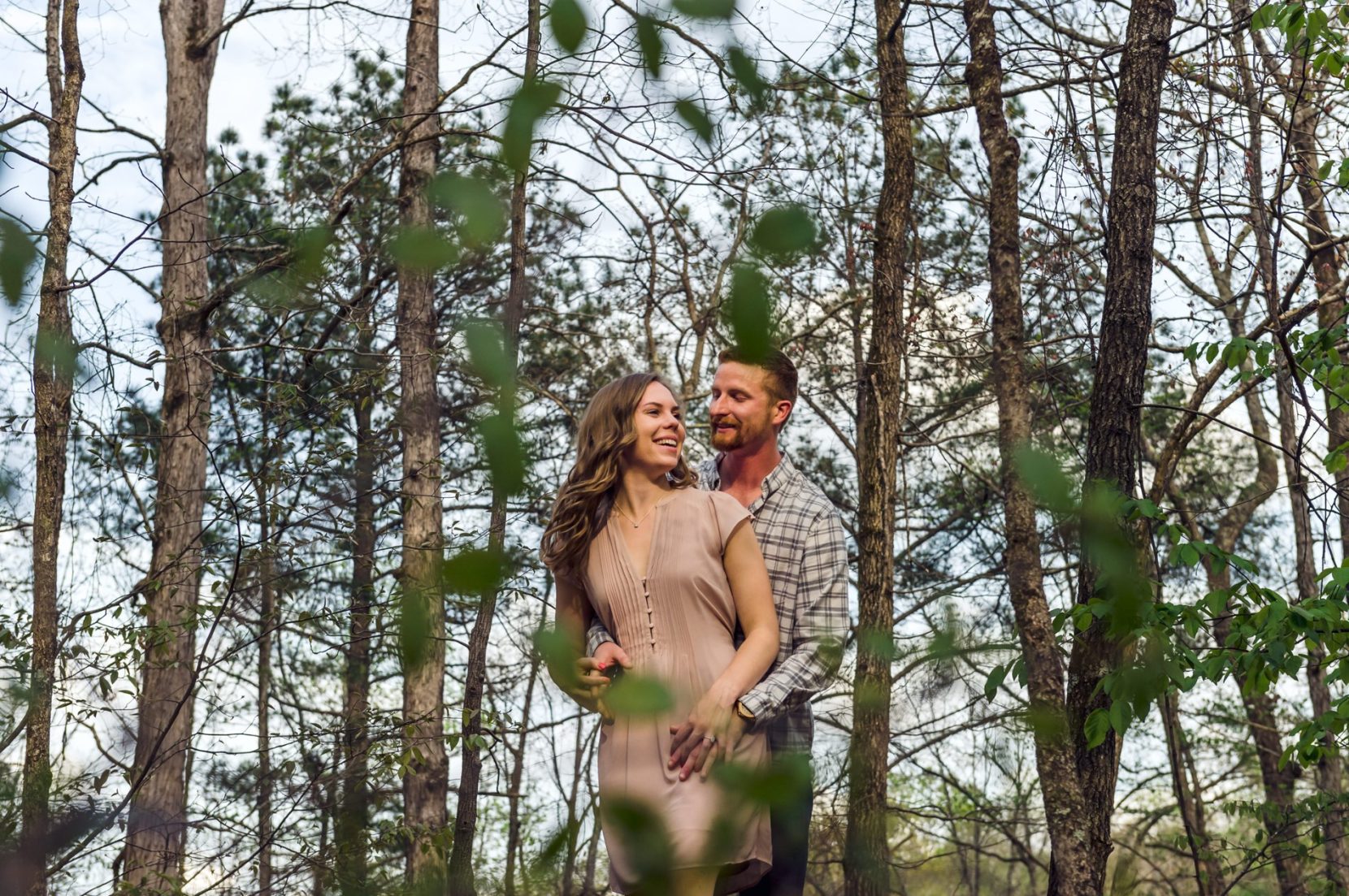 Playful couple having fun during engagement session at a park near Atlanta