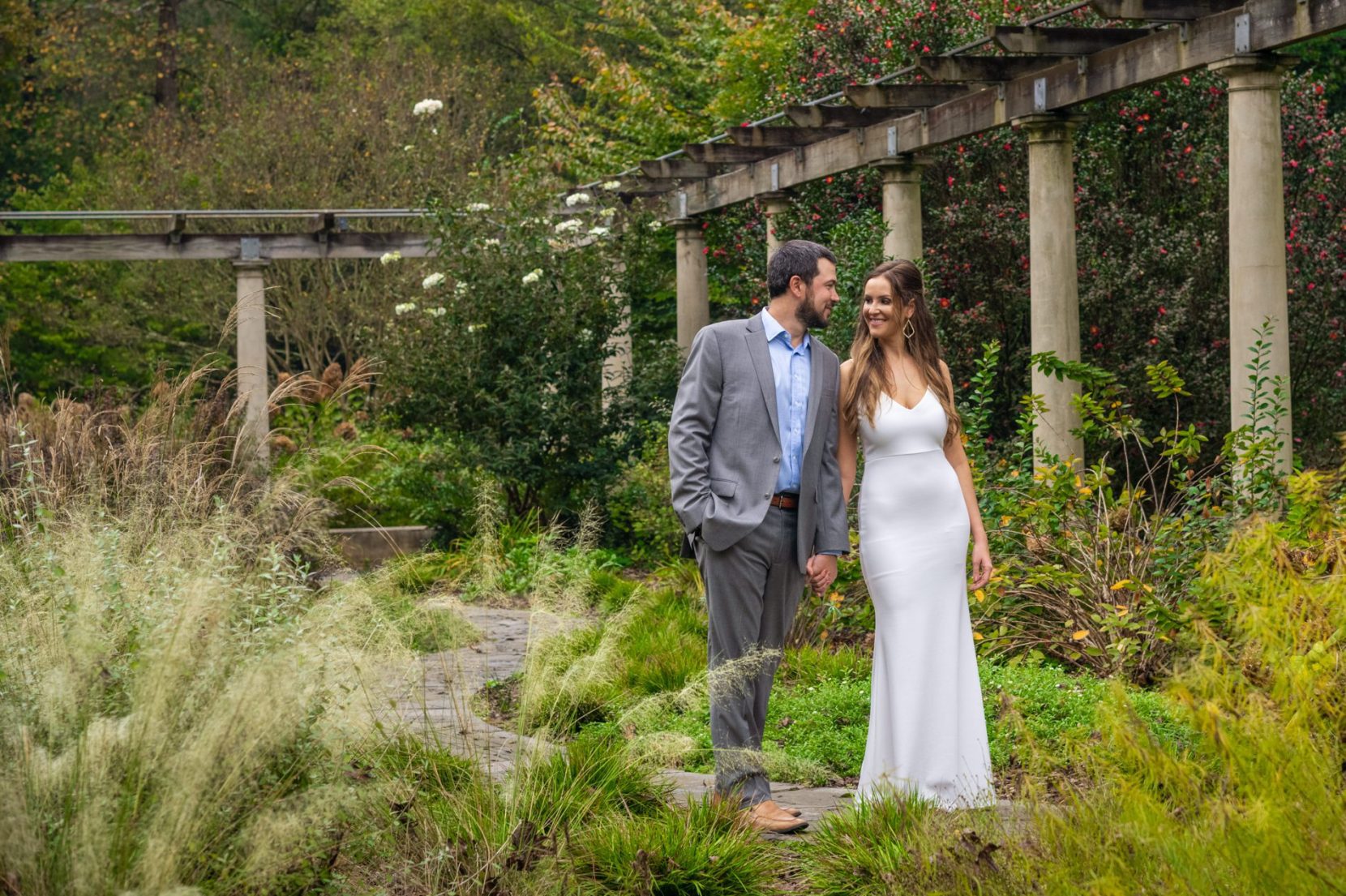 Couple stop for a quick moment while walking through Cator Woolford garden during engagement session