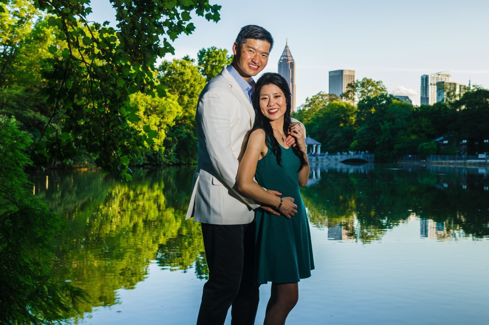 Couple portrait with Atlanta skyline during engagement session