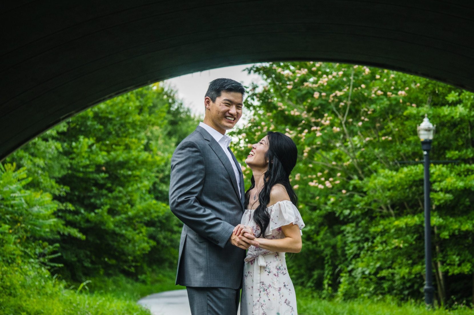 Candid spring engagement photo of couple at Piedmont Park in Atlanta