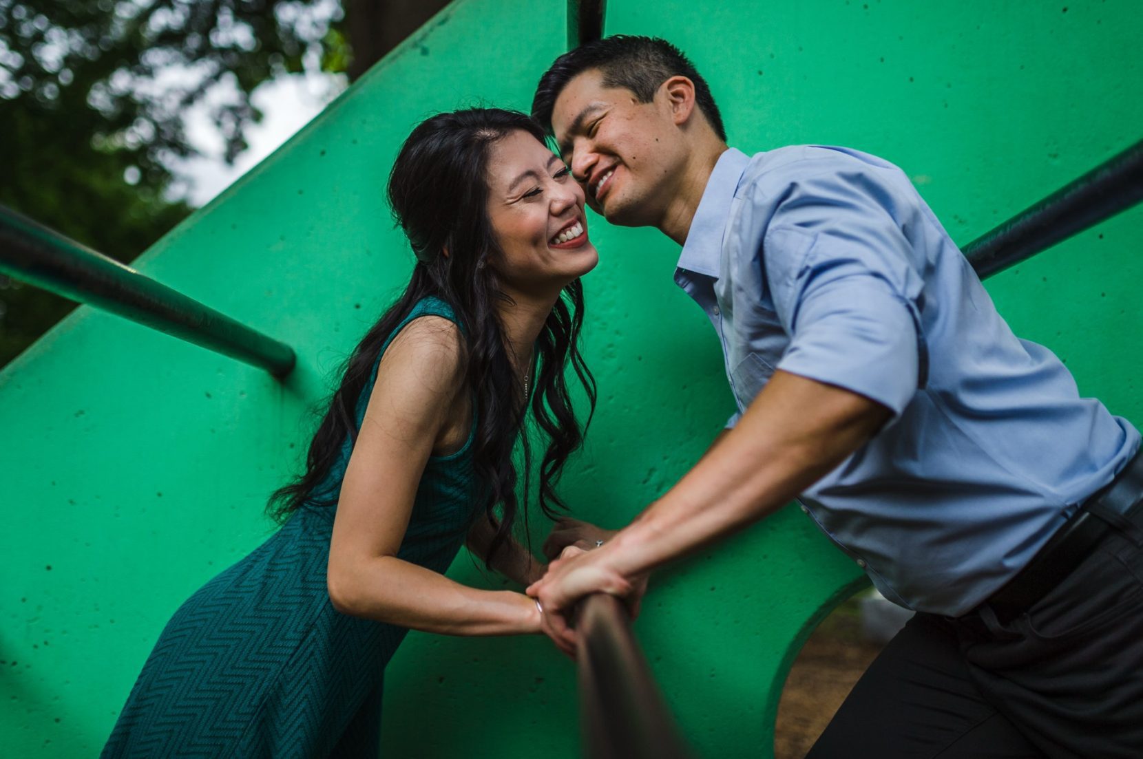 Playful engagement photo at Piedmont Park playground in Atlanta