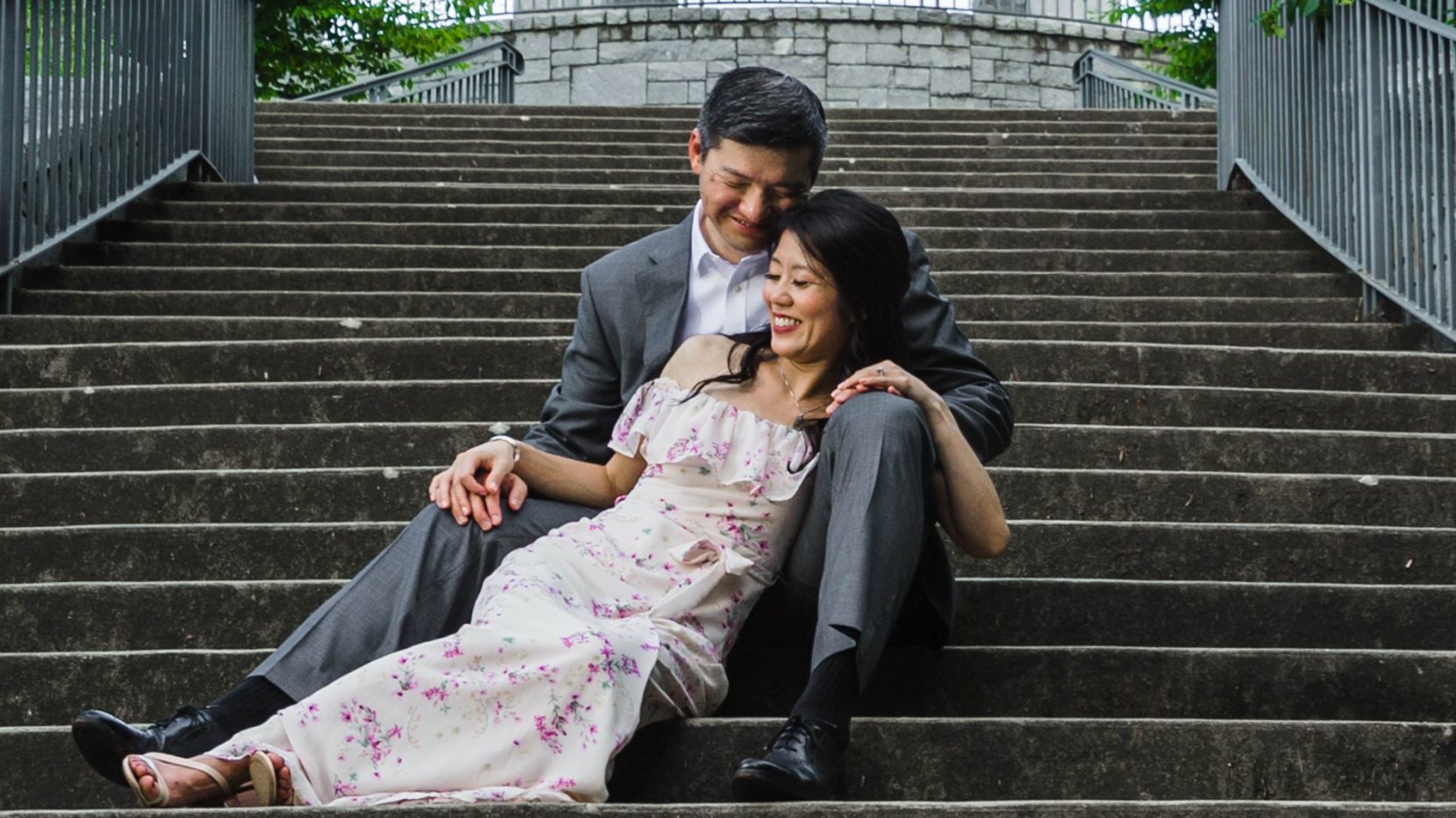 A romantic portrait of an engaged couple on the stairs in Piedmont Park Atlanta