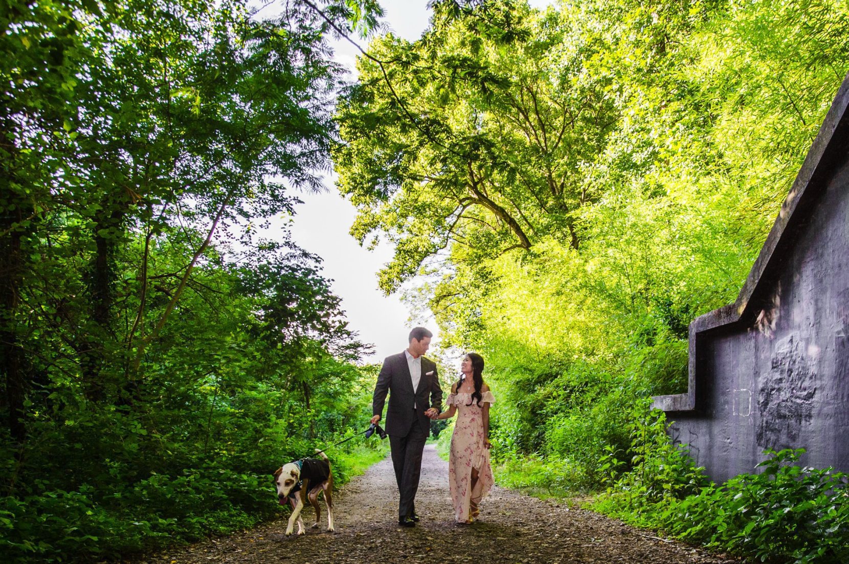 Candid walking with dog during engagement session at Piedmont Park