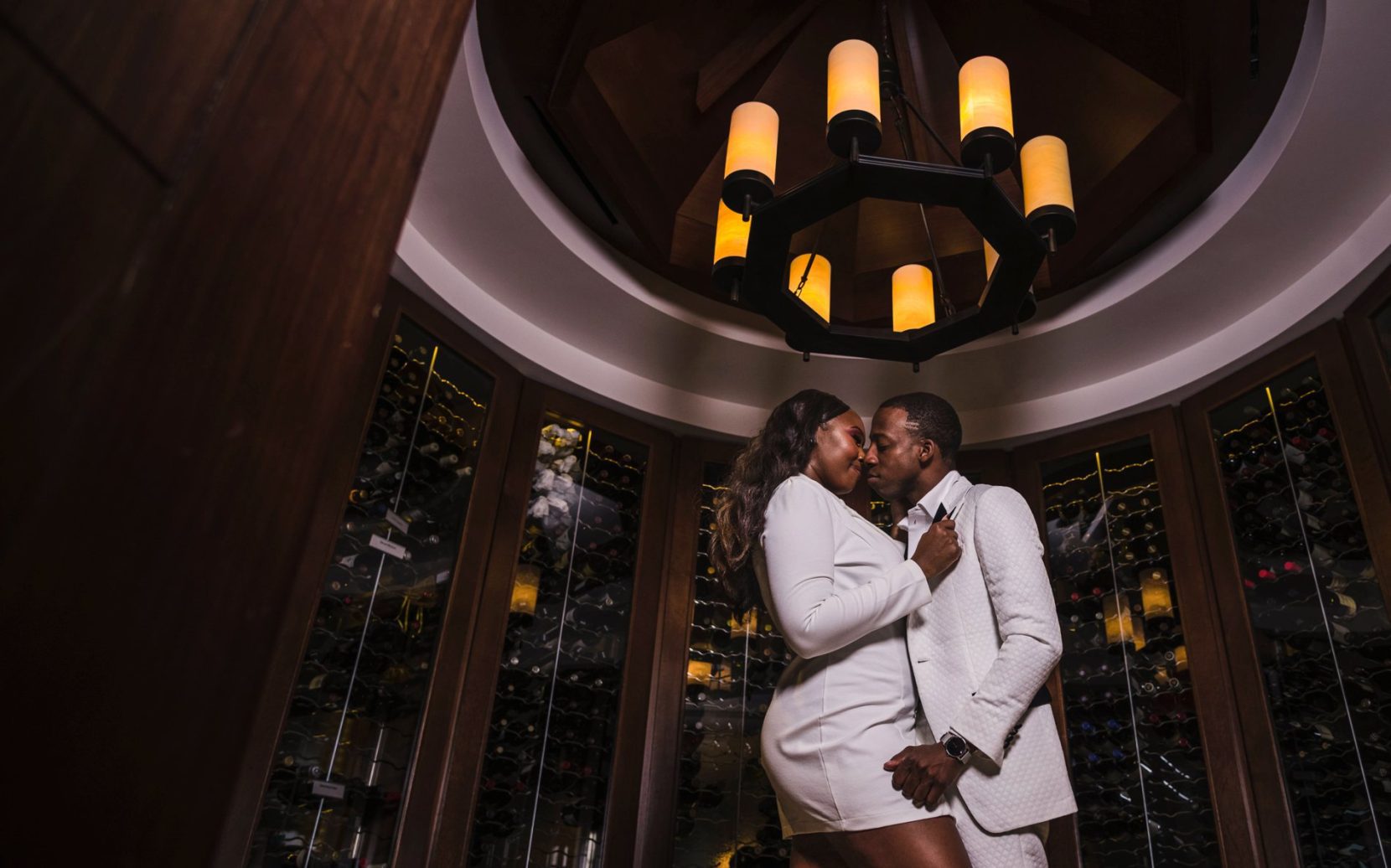 Romantic engagement portrait inside wine room at the Commerce Club