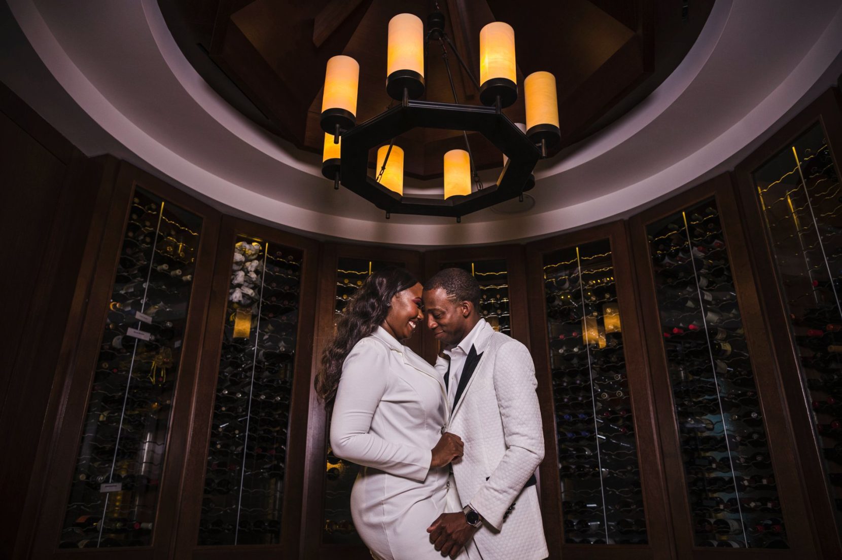 Couple engaging inside wine room at the Commerce Club