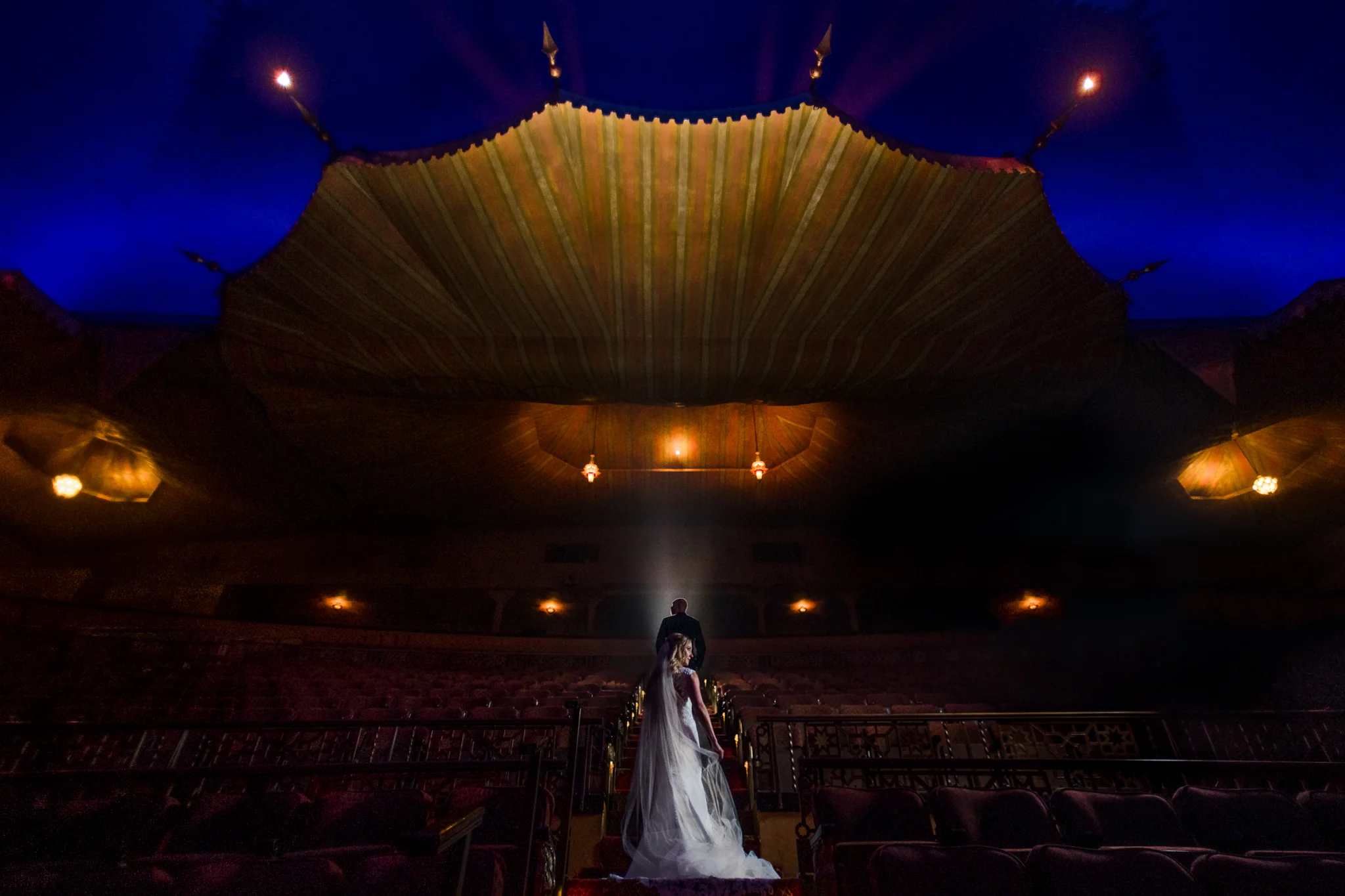 Bride and groom staggard under the fox theatre canopy in atlanta